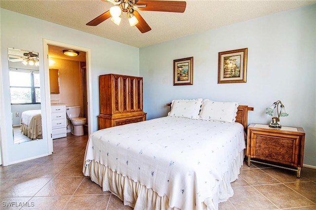 bedroom featuring light tile patterned floors, a textured ceiling, ensuite bath, and a ceiling fan