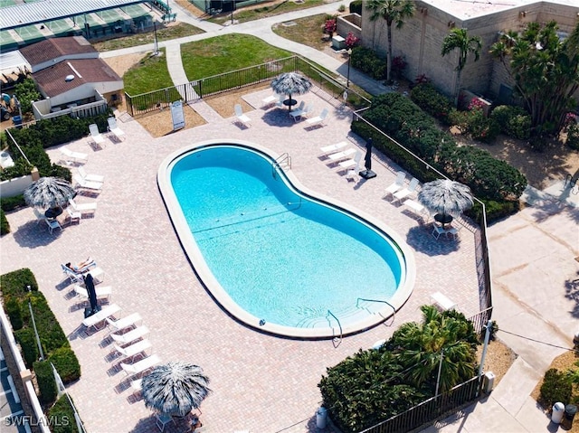 community pool featuring a fenced backyard and a patio area