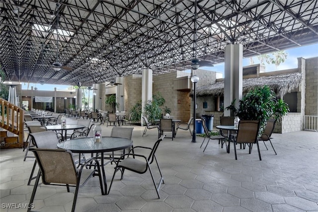 view of patio / terrace featuring outdoor dining area, ceiling fan, and a pergola