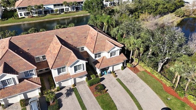 drone / aerial view with a water view and a residential view