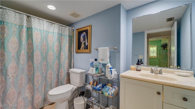 bathroom with visible vents, curtained shower, toilet, and vanity