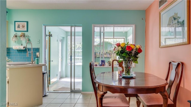 dining space featuring light tile patterned floors and visible vents