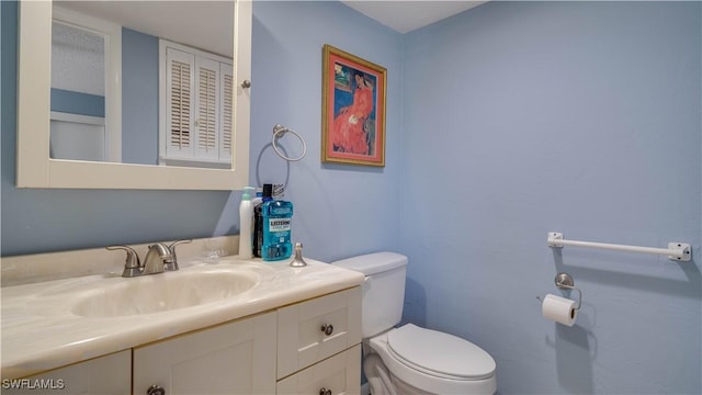 bathroom with toilet and vanity