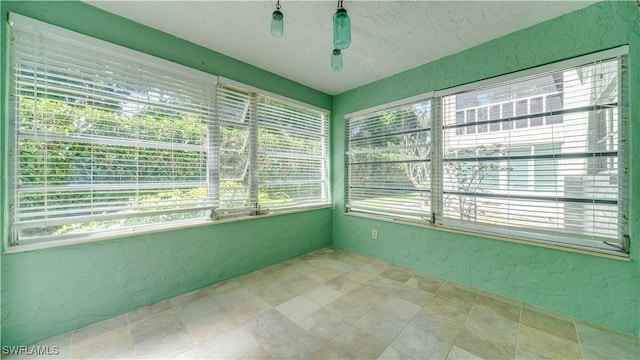 unfurnished sunroom featuring a wealth of natural light