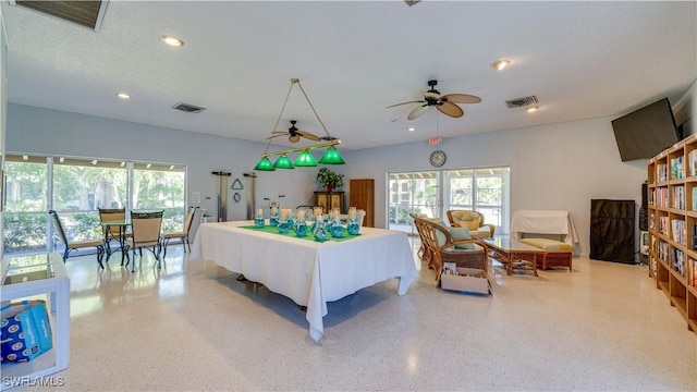 interior space featuring speckled floor, visible vents, and a healthy amount of sunlight