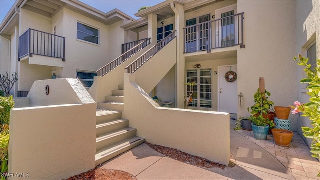 property entrance with stucco siding