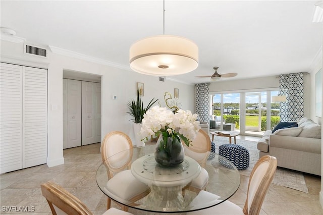 dining room featuring ornamental molding, visible vents, and a ceiling fan