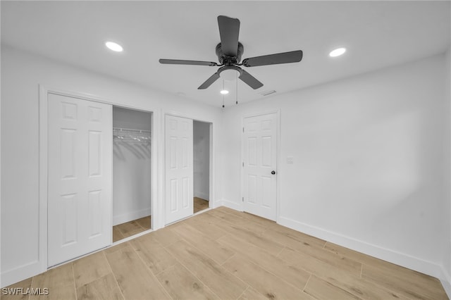 unfurnished bedroom featuring light wood-type flooring, visible vents, baseboards, and recessed lighting