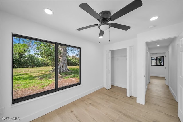 unfurnished bedroom with ceiling fan, light wood-style flooring, recessed lighting, baseboards, and a closet