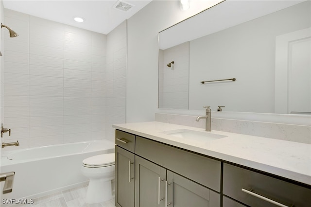 bathroom with visible vents, shower / bathing tub combination, toilet, vanity, and recessed lighting