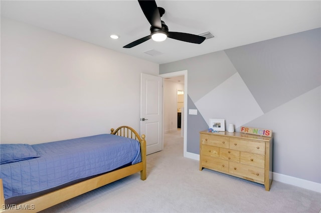 bedroom with a ceiling fan, visible vents, light carpet, and baseboards