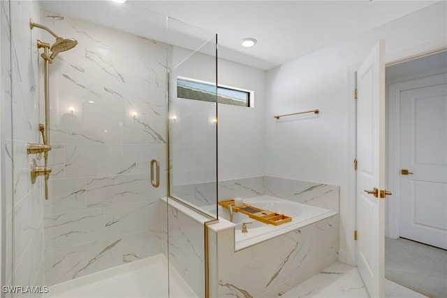 bathroom featuring a garden tub, marble finish floor, and a marble finish shower