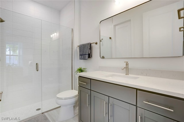 full bath featuring toilet, a shower stall, and vanity