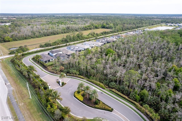 aerial view featuring a water view and a wooded view