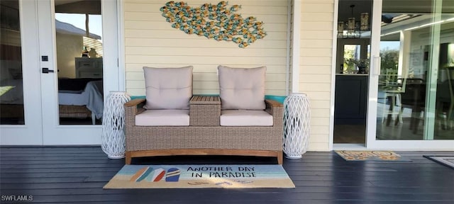 view of wooden balcony with a wooden deck, an outdoor hangout area, and french doors