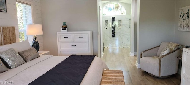 bedroom with wood finished floors and ensuite bathroom