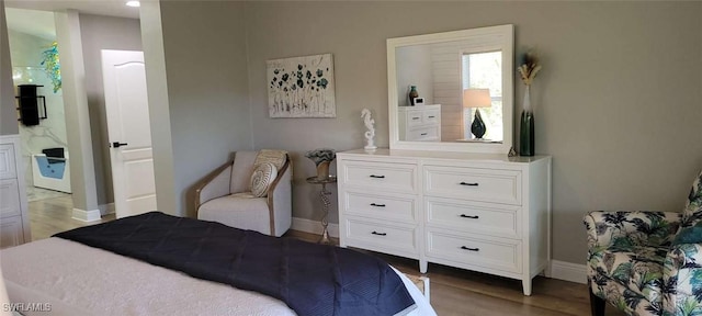 bedroom featuring baseboards and wood finished floors