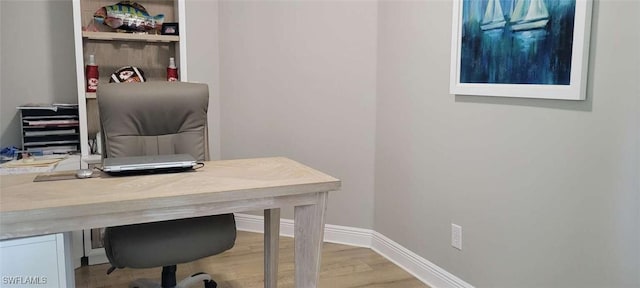 office area with baseboards and wood finished floors