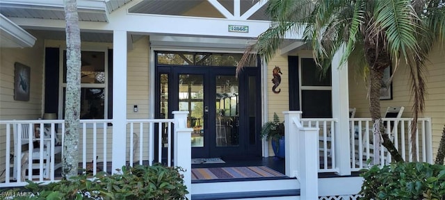 entrance to property featuring a porch and french doors