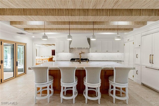 kitchen with wood ceiling, white cabinets, beam ceiling, tasteful backsplash, and custom range hood