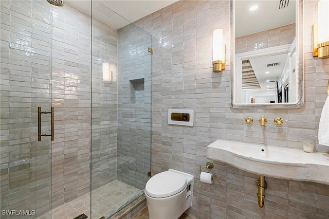 full bathroom with visible vents, toilet, tile walls, and a shower stall