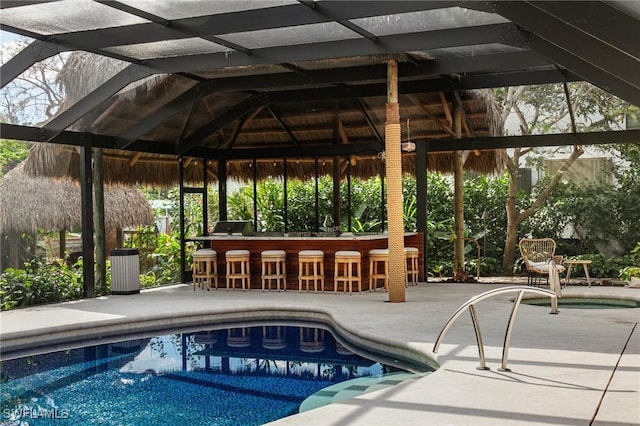 outdoor pool featuring a patio and outdoor dry bar