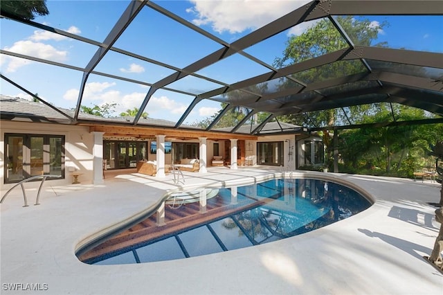 outdoor pool featuring french doors, glass enclosure, and a patio