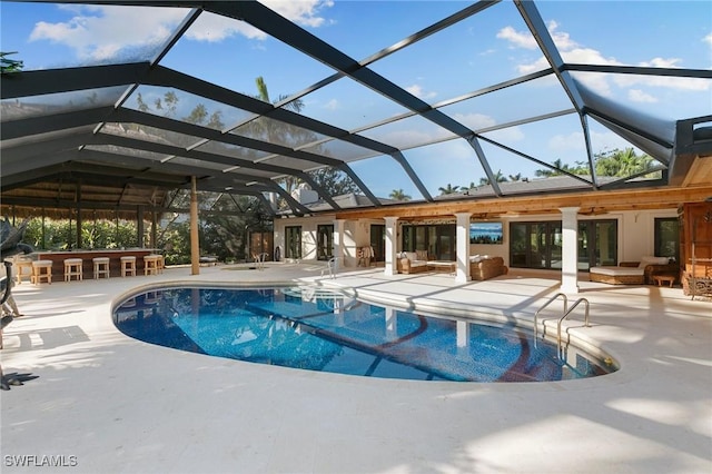 outdoor pool with glass enclosure, an outdoor living space, a patio area, and outdoor dry bar