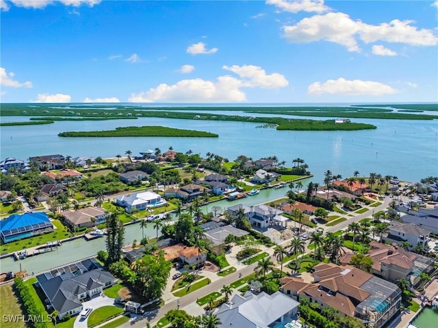 drone / aerial view featuring a residential view and a water view