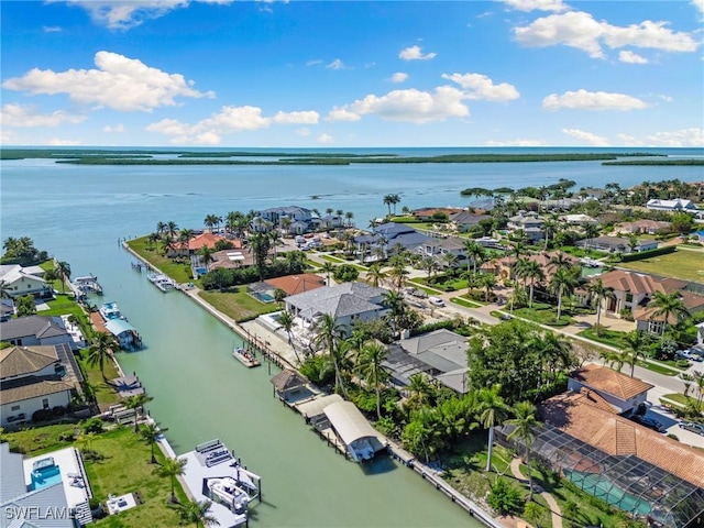 drone / aerial view with a water view and a residential view