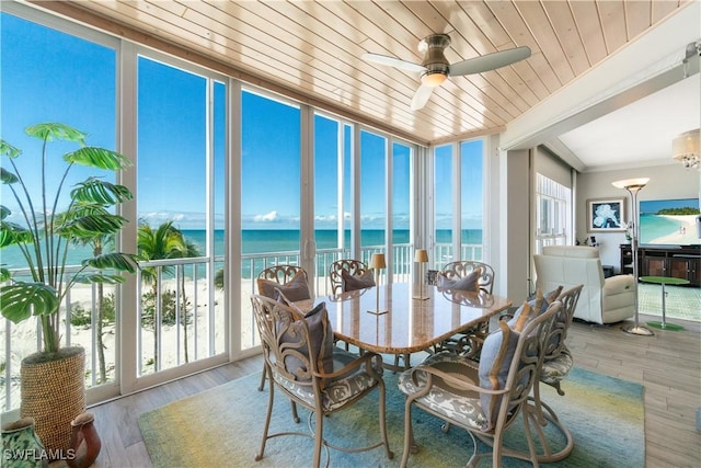 sunroom / solarium with a wealth of natural light, wooden ceiling, and ceiling fan