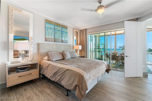 bedroom with access to exterior, wood finished floors, and ceiling fan