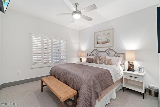 bedroom featuring baseboards, light carpet, and a ceiling fan