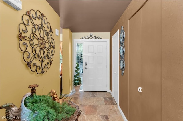 entryway featuring stone finish floor