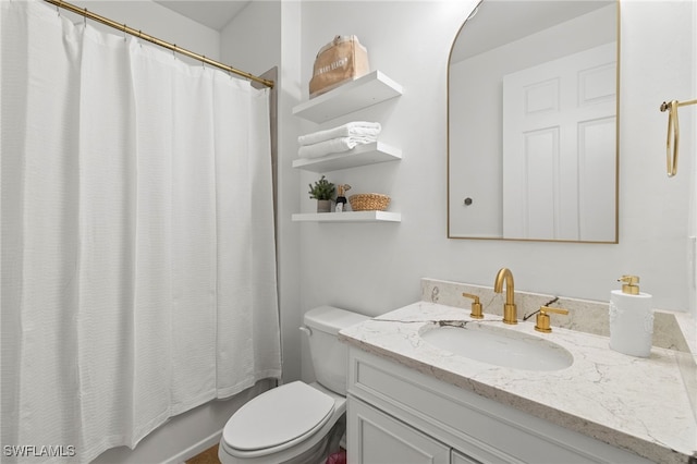 bathroom with toilet and vanity