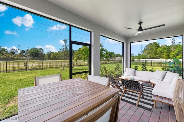 sunroom / solarium with a ceiling fan