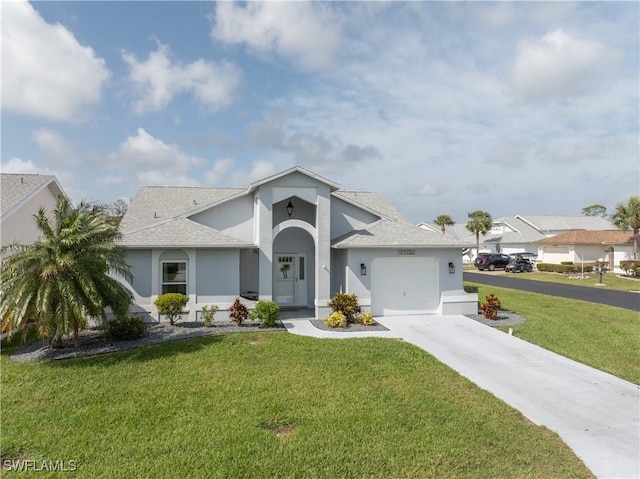 view of front of house featuring a garage, a front lawn, and stucco siding