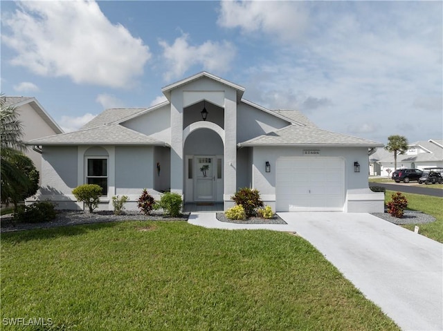 single story home featuring a garage, a front yard, a shingled roof, and stucco siding