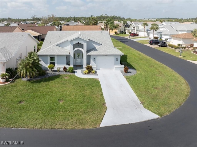 view of front of property with a shingled roof, concrete driveway, an attached garage, a front yard, and a residential view