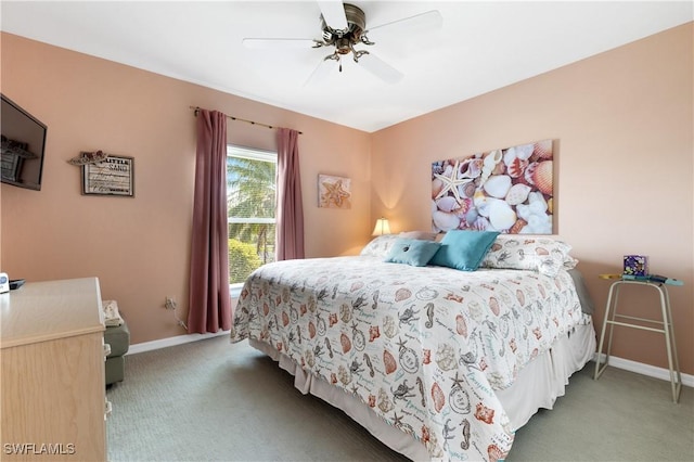 carpeted bedroom with ceiling fan and baseboards