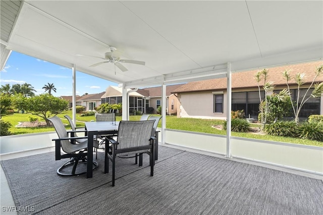 sunroom / solarium featuring ceiling fan