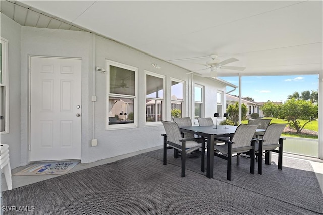 sunroom / solarium with a ceiling fan