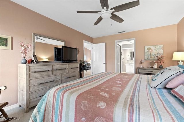 carpeted bedroom featuring ceiling fan, connected bathroom, visible vents, and baseboards