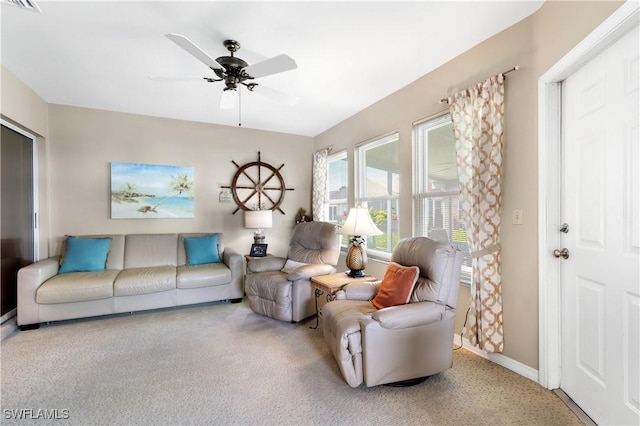 carpeted living area featuring a ceiling fan, visible vents, and baseboards