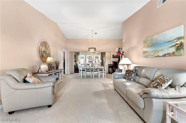 living area with light carpet, a high ceiling, and visible vents