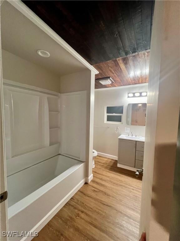 bathroom featuring baseboards, toilet, wooden ceiling, wood finished floors, and vanity