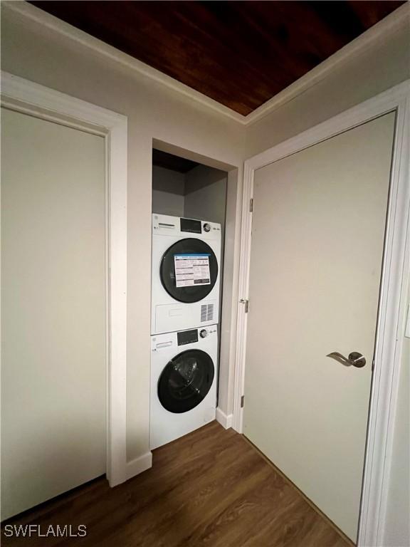 washroom featuring laundry area, wood ceiling, dark wood finished floors, and stacked washer / dryer