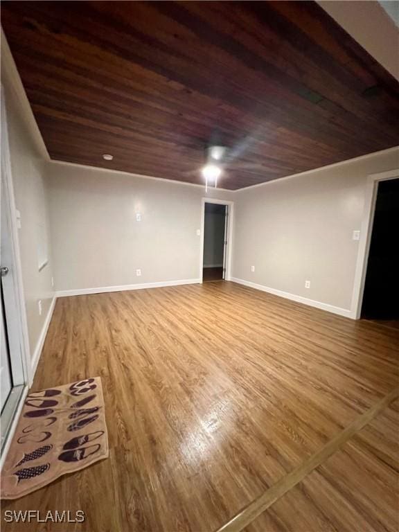 unfurnished room featuring wooden ceiling, baseboards, and wood finished floors