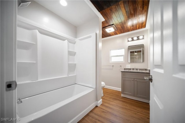 1157/1155 4th Way N, Fort Myers, FL 33903 - full bath featuring baseboards, vanity, toilet, bathing tub / shower combination, and wood finished floors