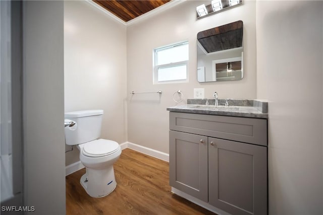 1157/1155 4th Way N, Fort Myers, FL 33903 - half bathroom with toilet, vanity, baseboards, wood finished floors, and crown molding